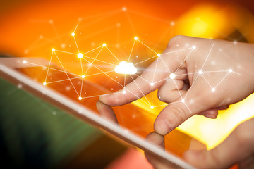 Fingers touching tablet with cloud concept
