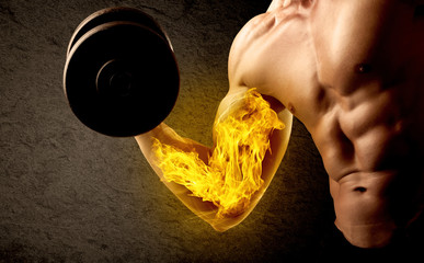 Muscular bodybuilder lifting weight with flaming biceps concept