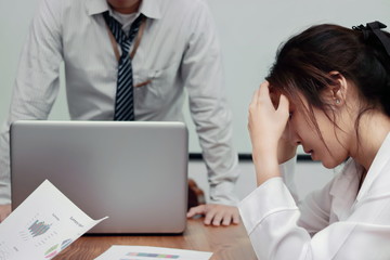 Stressed exhausted young Asian business woman suffering from severe depression between meeting in office.