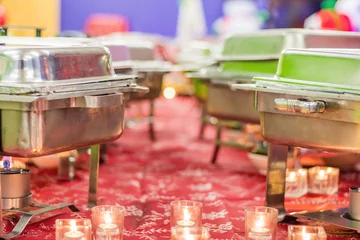 Fotobehang Holiday Party buffet trays all set up before the feast with bunson burners and flames © rabbitti