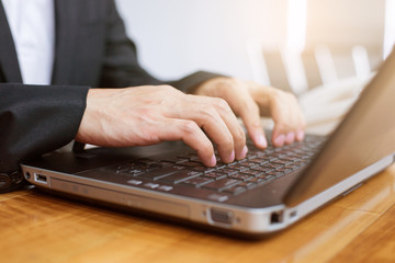 close up hand of businessman typing keyboard on laptop. business people and technology concept.