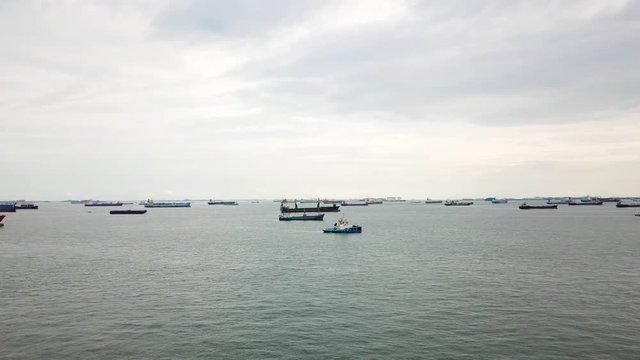 Singapore. December 04, 2017: Aerial footage of many cargo ships on the Singapore strait, waiting to enter one of the busiest ports in the world. Shot in 4k resolution