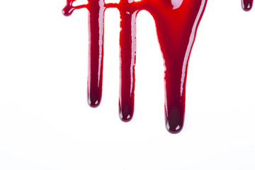 Studio shot of fake blood dripping and splattered.