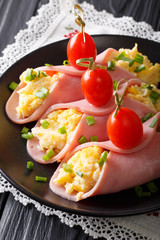ham stuffed with omelets and tomatoes close-up. vertical