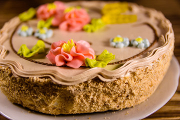 Kiev cake with cream on wooden table