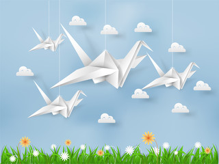 illustration vector of white origami paper bird flying on blue sky over field of grasses and flower with cloud, beautiful environment in paper art and craft style