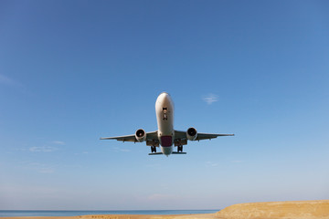 Passenger airplane landing over sea in summer season.