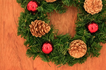Close up christmas wreath on wooden background, soft focus