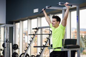 Young fit man wearing sportswear training at the gym