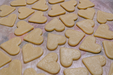 raw cookies in the shape of hearts, top view.