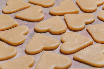 Fototapeta na wymiar raw cookies in the shape of hearts, top view.