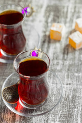 Red tea in turkish glasses on a wooden table