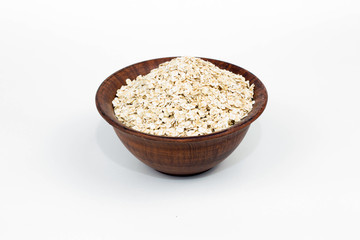 raw oat flakes in a clay plate
