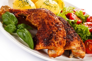 Roast chicken legs with boiled potatoes and vegetables 