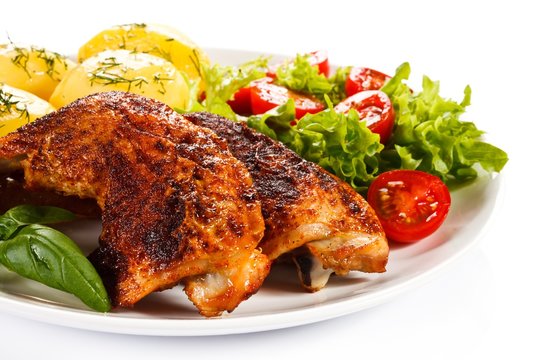 Roast chicken legs with boiled potatoes and vegetables 