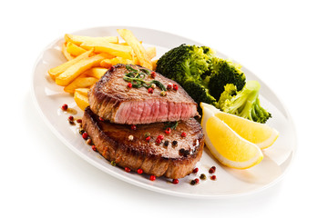 Grilled beefsteak with french fries and broccoli on white background 