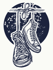 Boots hanging from electrical wire tattoo and t-shirt design. Symbol of freedom, street culture, graffiti, street art. Sneakers on wires in space © intueri