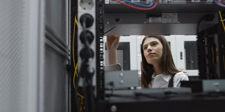woman using computer in server room