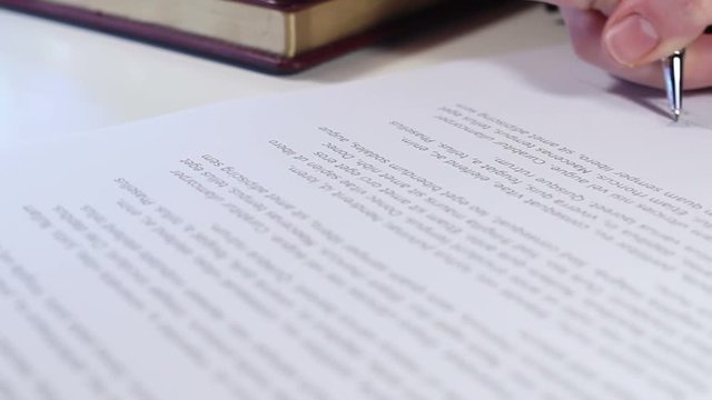 Businessman signs the documents. Signature is fake.
