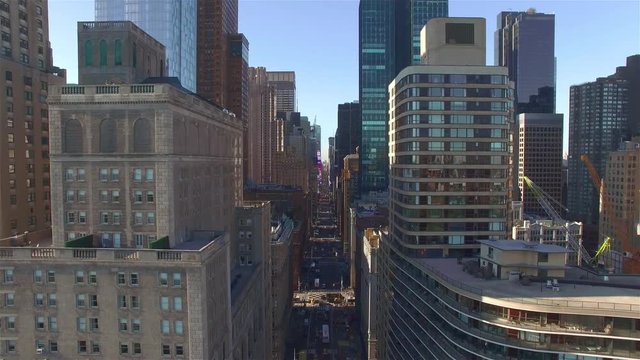 Aerial shot of Downtown Manhattan architecture in New York City. Camera hovering in the air above the intersection of West 59th Street and 7th Avenue. Camera No motion.