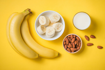 Fresh made banana smoothie in a glass on yellow background © makistock