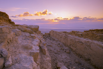 Beautiful purple sunrise over Masada fortress. Ruins of King Herod's palace in the Judaean Desert