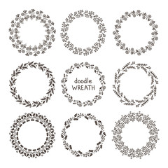 Doodle wreath. Vector hand drawn set of round floral wreaths. Black flower and brunch silhouettes. Isolated. On white background.