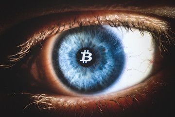 An enlarged image of eye with a blue iris, eyelashes and sclera. Bitcoin symbol inside the pupil....