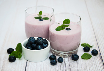 Glasses with blueberry yogurt on a table
