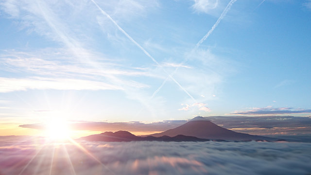 Fototapeta 富士山を取り巻く雲海と日の出