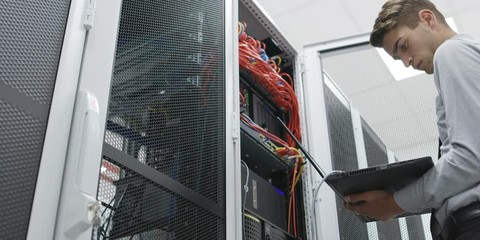A Man Working In A Server Room. Shot on RED Helium 8K