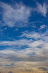 View of blue sky with soft clouds, vertical oriented