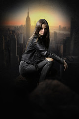 Pretty young woman thief over the rooftops wearing a black leather jaket. 