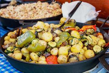 Roasted vegetables for potatoes in a cast-iron pan. Refreshment.