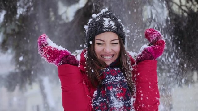 Portrait young beautiful woman standing park falls snow smiles christmas snowball winter young beautiful girl happiness joy outdoor throwing white hat holiday park play attractive slow motion