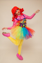 a clowness girl in bright clothes. Create a holiday for children