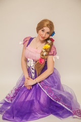 girl in a princess dress with a wig on her head. Create a holiday for children