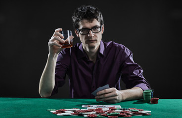 casino player in glasses playing poker