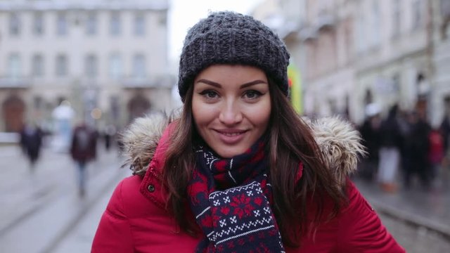 Close up face happy beautiful young woman with charming smile returns looking camera happiness holiday lifestyle snowflakes cold snow white beauty face winter attractive slow motion