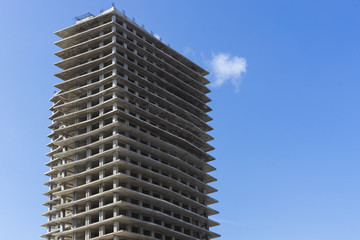 The construction of multi-storey buildings against the sky