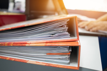 Many Stacks of document folders in office for Annual Report files on Abstract blurred photo of...