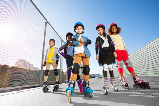 Happy multiethnic kids in rollerblades  outdoors