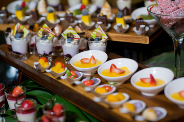 Glass shots  pastry. wedding catering food. mini canapes food.  tasty dessert. Beautiful decorate catering banquet table.  snacks and appetizers. wedding celebration