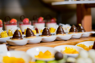 Glass shots  pastry. wedding catering food. mini canapes food.  tasty dessert. Beautiful decorate catering banquet table.  snacks and appetizers. wedding celebration