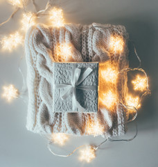Winter holiday Christmas decorations, white gift boxes and knitt