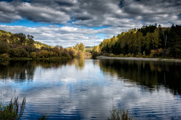 A picturesque river and a textured sky in autumn