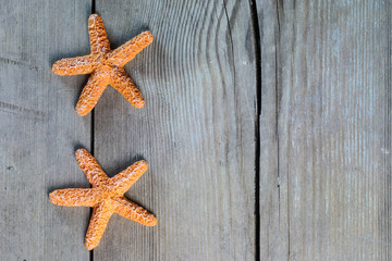 Marine theme. Wooden background. Sea stars. Place for text.