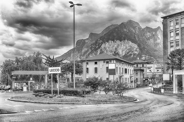 City intersection with scenic mountain in the background, Lecco, Italy