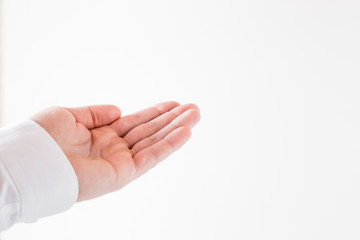 Outstretched man's hand on the white background. Mock up for charity, religion or support and advertising offers or other ideas. Trust concept. Empty place for a text.