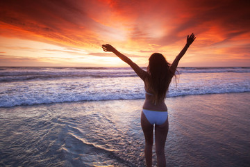 Fototapeta na wymiar Woman on beach at sunset